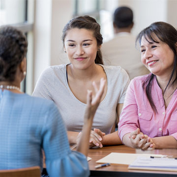 Mother and daughter receiving financial advice at a bank