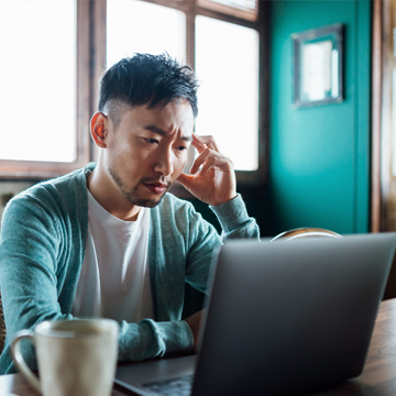 Concerned man reading the latest news about spoofing attempts