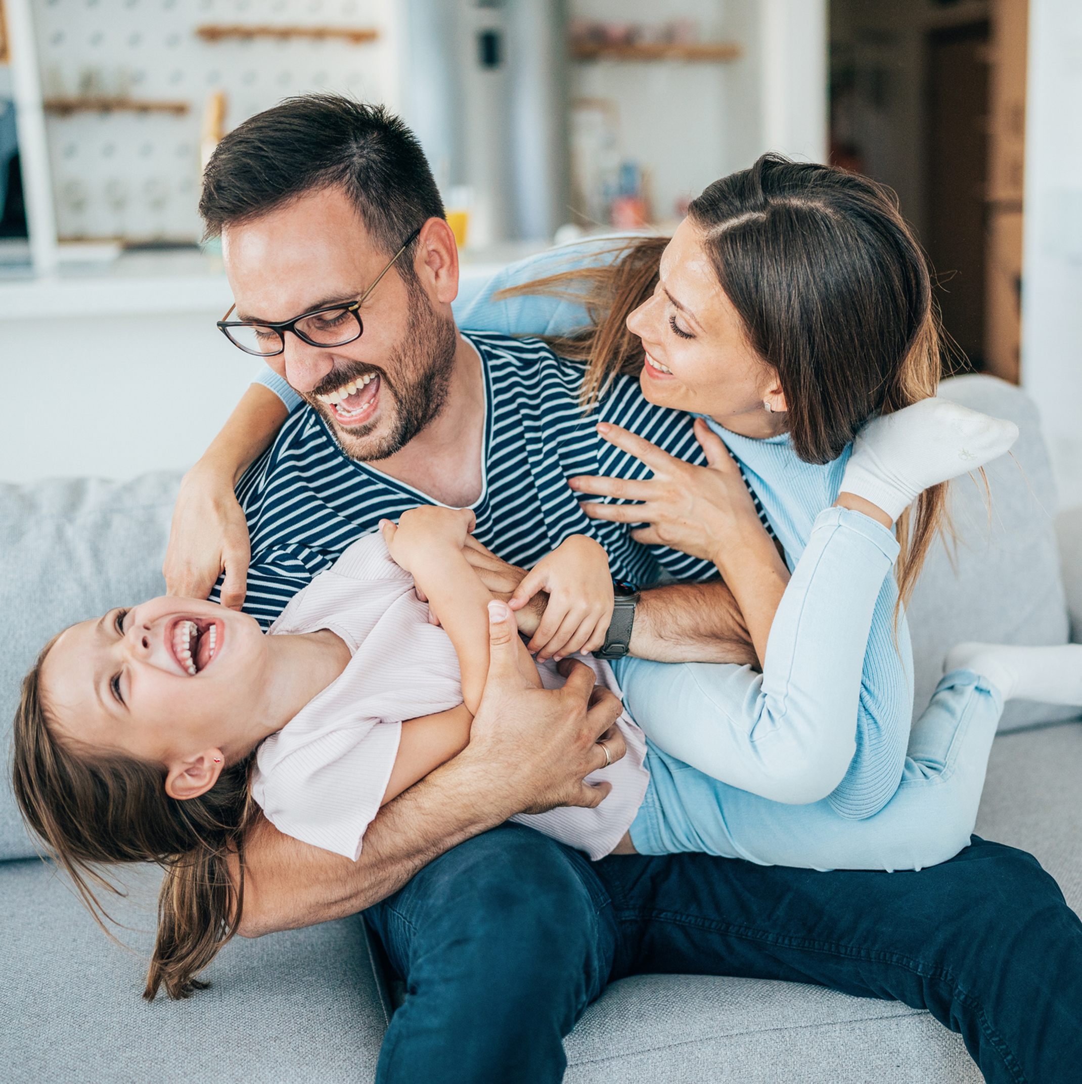 Family on a couch enjoying each other’s company