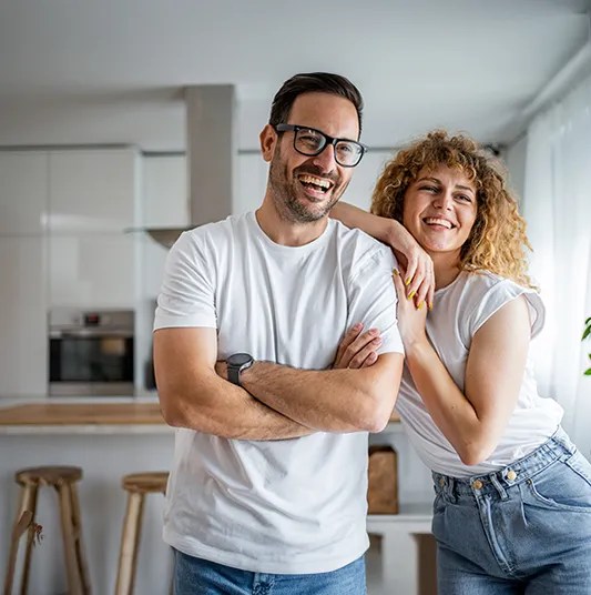 Couple looking away from the camera indoors smiling