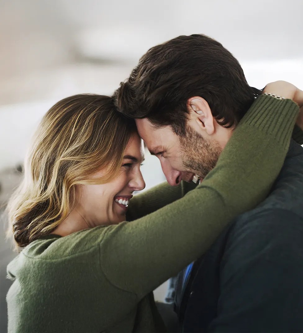 Couple holding each other close and smiling